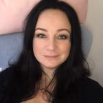 Portrait dark haired women looking content.