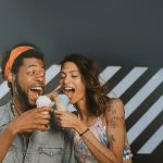 A man and a women about to bite ice cream